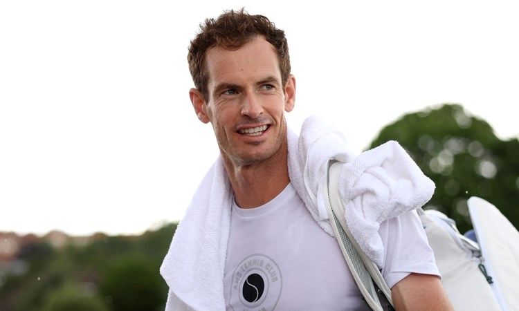 Andy Murray wearing white while smiling at the All England Club