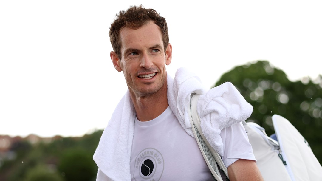 Andy Murray wearing white while smiling at the All England Club