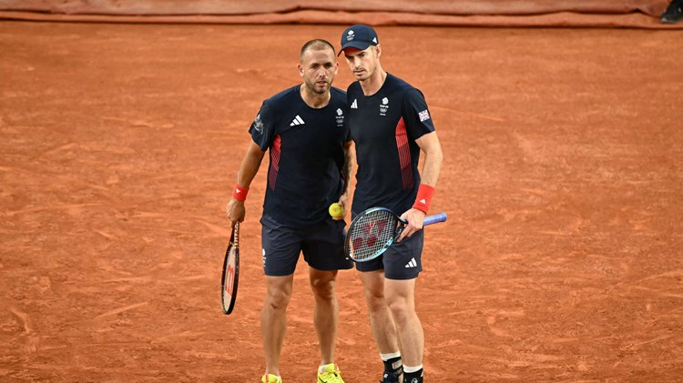 Dan Evans and Andy Murray chatting on court during the Olympics doubles quarter-final