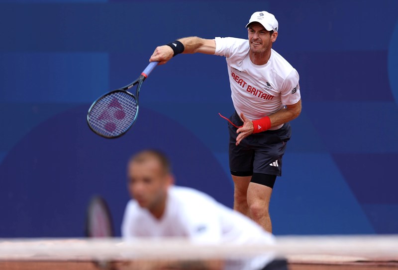 Andy Murray hits a serve in training for the Olympics