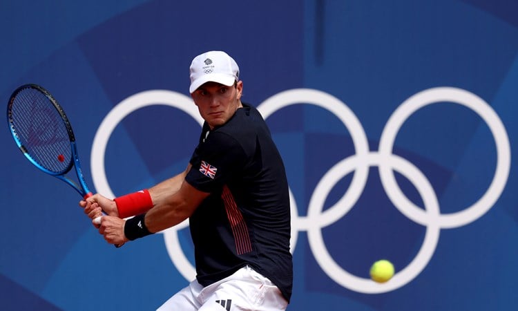 Jack Draper lines up a backhand in the opening round of the Olympics