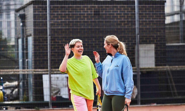 Two women about to high five