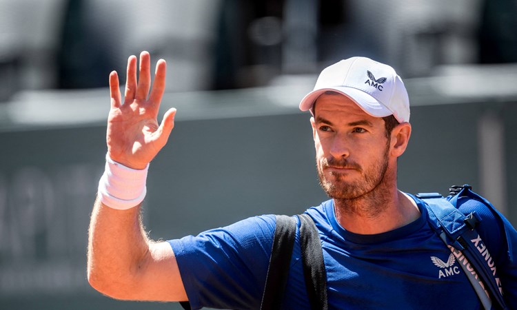 Andy Murray waves to the fans as he walks off court