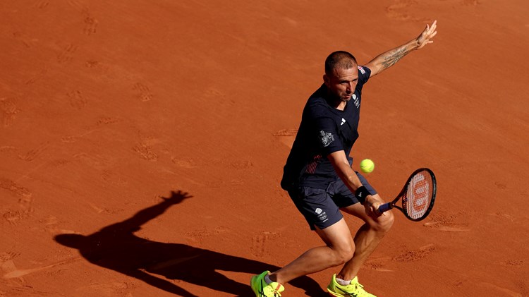 Dan Evans hits a backhand in the second round at the Olympics