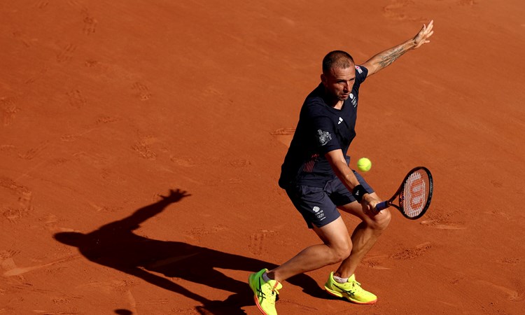 Dan Evans hits a backhand in the second round at the Olympics