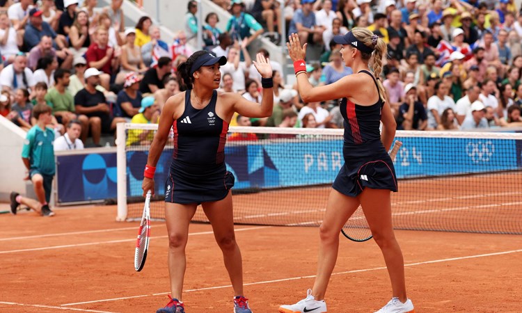 Heather Watson and Katie Boulter high five during their second round match at the Olympics