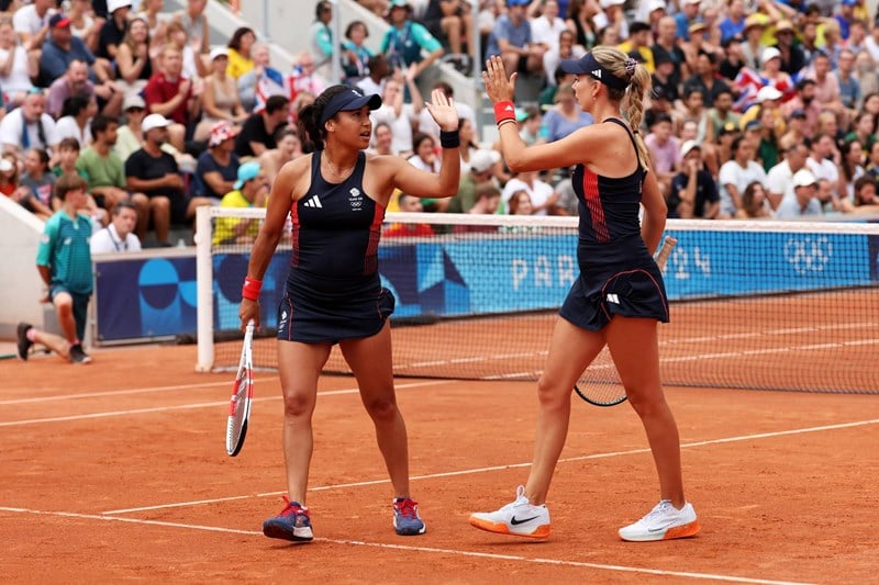 Heather Watson and Katie Boulter high five during their second round match at the Olympics