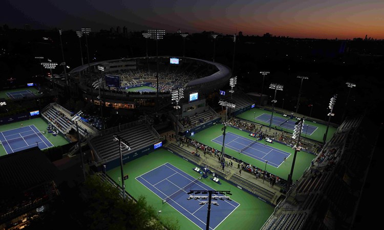 Four tennis courts surrounding Arthur Ashe Stadium at the US Open complex