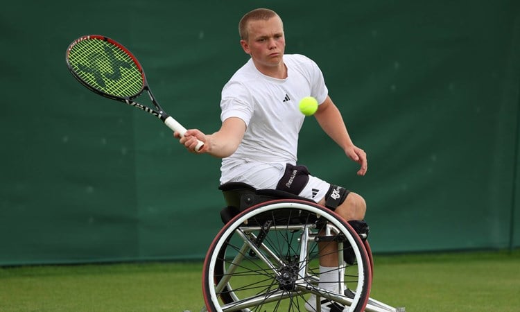 Ben Bartram hits a forehand at Wimbledon 2024