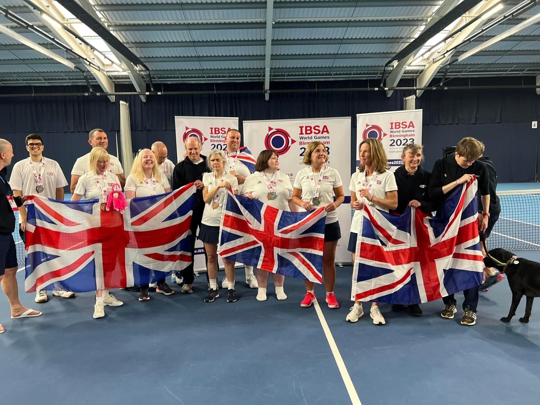 The GB visually impaired tennis team photographed together holding the Union Jack at the IBSA World Games 2023 in Birmingham, England.