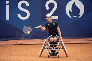 Wheelchair tennis star Greg Slade hitting a forehand on court at the Paralympics