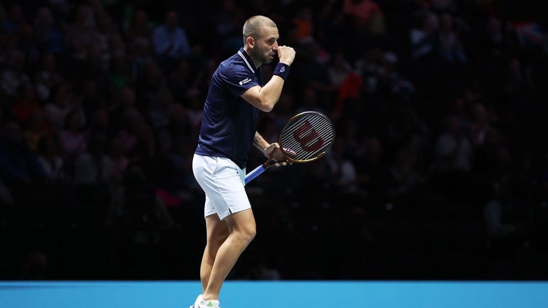 Dan Evans clenching his fist while celebrating on court at the Davis Cup