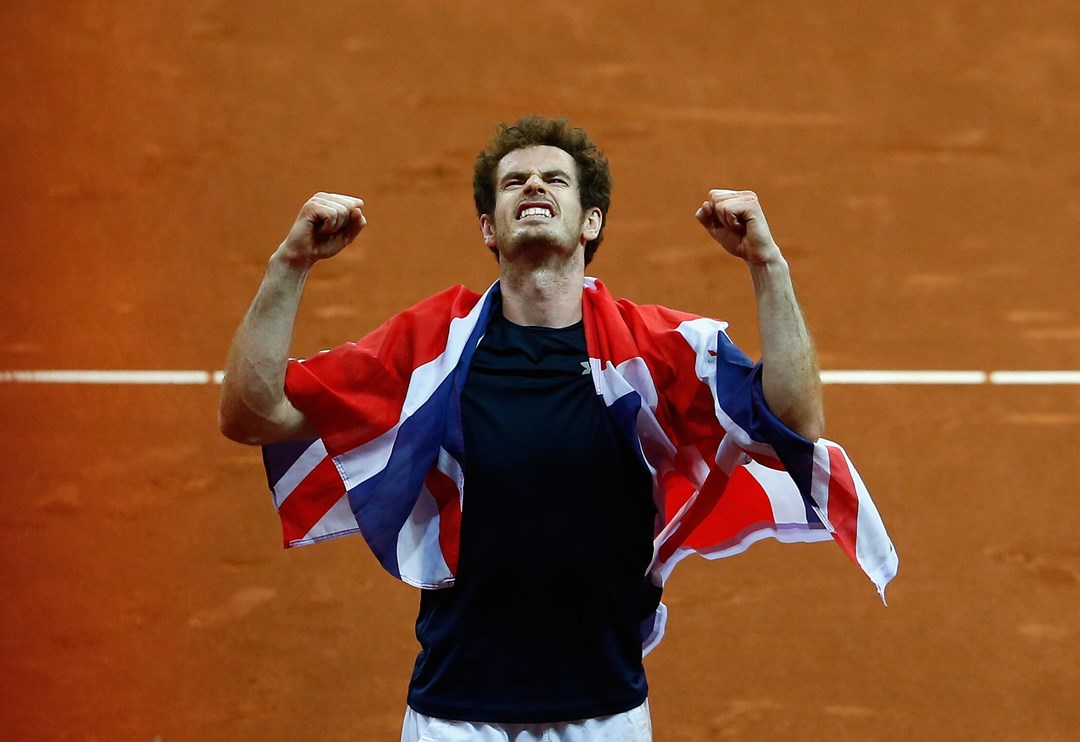 Andy Murray of Great Britain celebrates draped in Union Jack flag