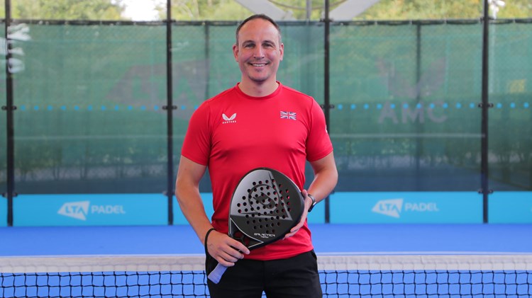 Steve Yeardley posing with a bat on a padel court