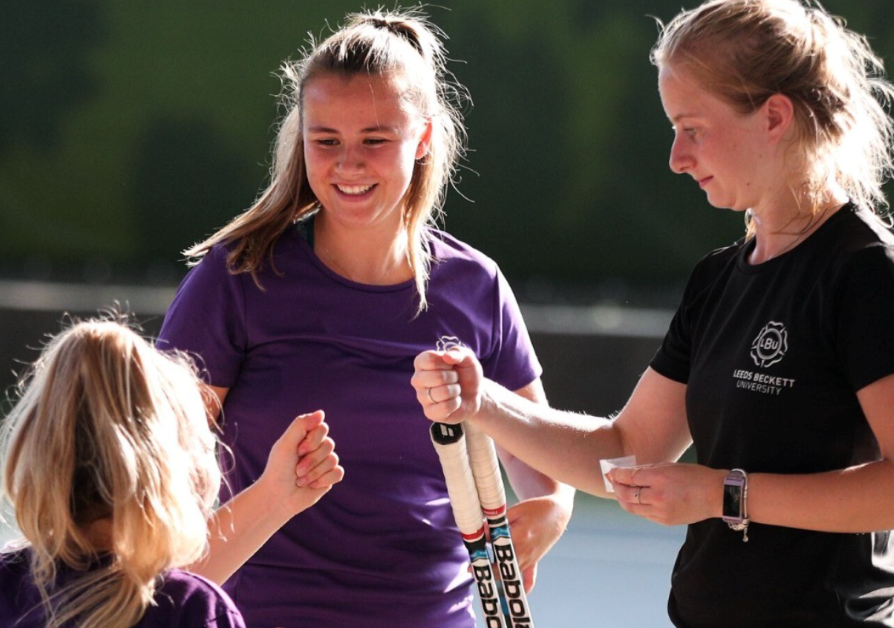 University tennis players fist bumping