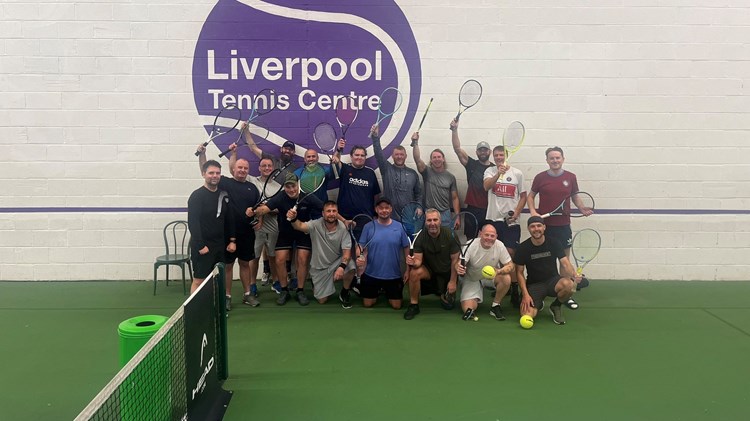 Residents of the Damien John Kelly House in Liverpool pictured on court holding their rackets above their head during a tennis session at the Liverpool Tennis Centre. 