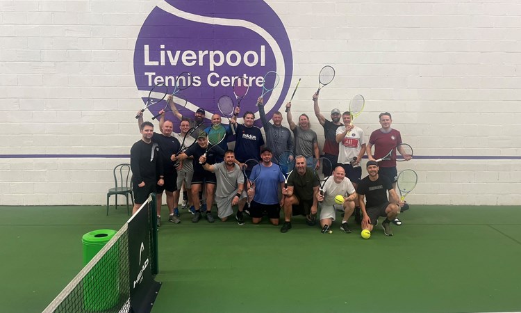 Residents of the Damien John Kelly House in Liverpool pictured on court holding their rackets above their head during a tennis session at the Liverpool Tennis Centre. 