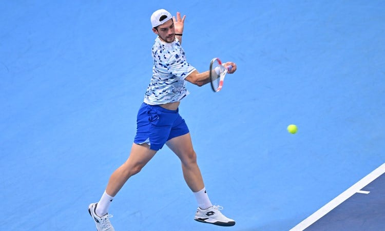 British doubles tennis player Julian Cash hitting a forehand on court at the Japan Open