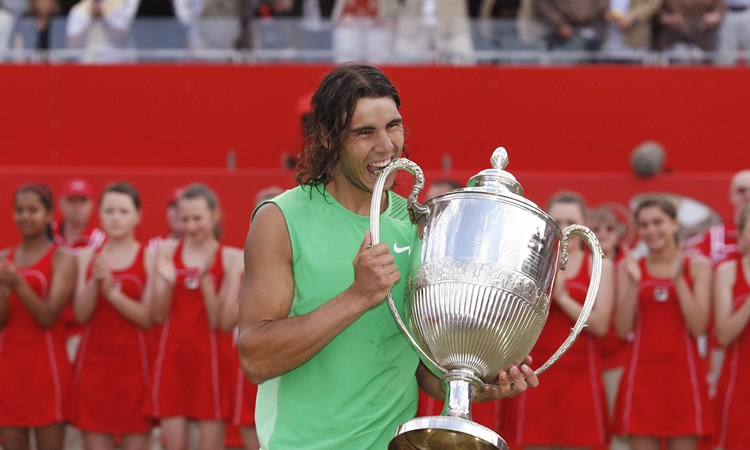 Rafael Nadal bites the Queen's Club trophy after beating Novak Djokovic in the 2008 final