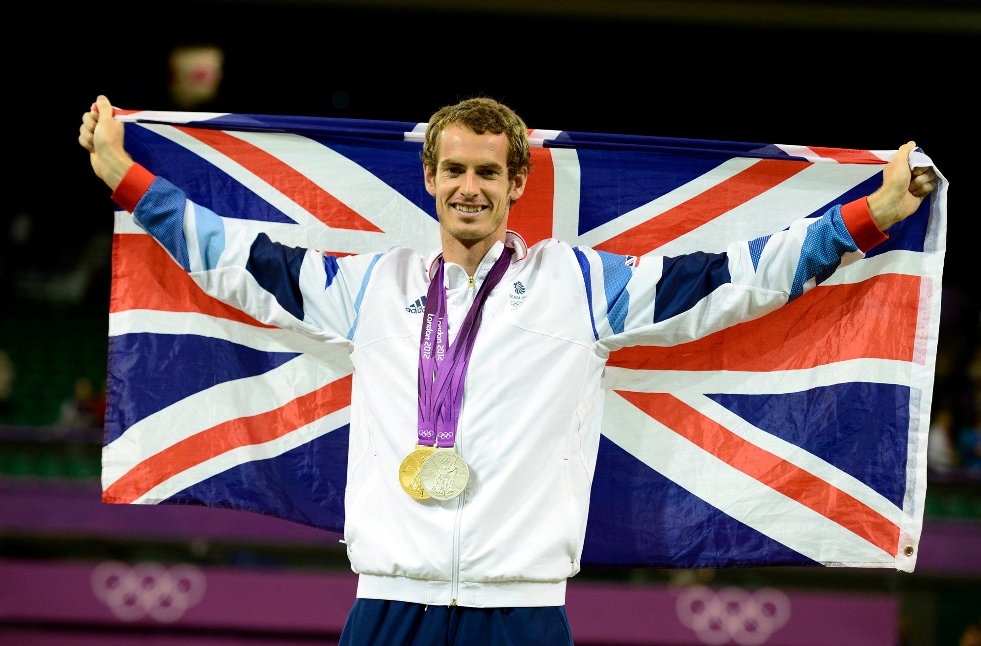 Andy Murray holds the union jack flag with his Olympic gold medal (singles) and silver medal (mixed doubles) at the 2012 London Games