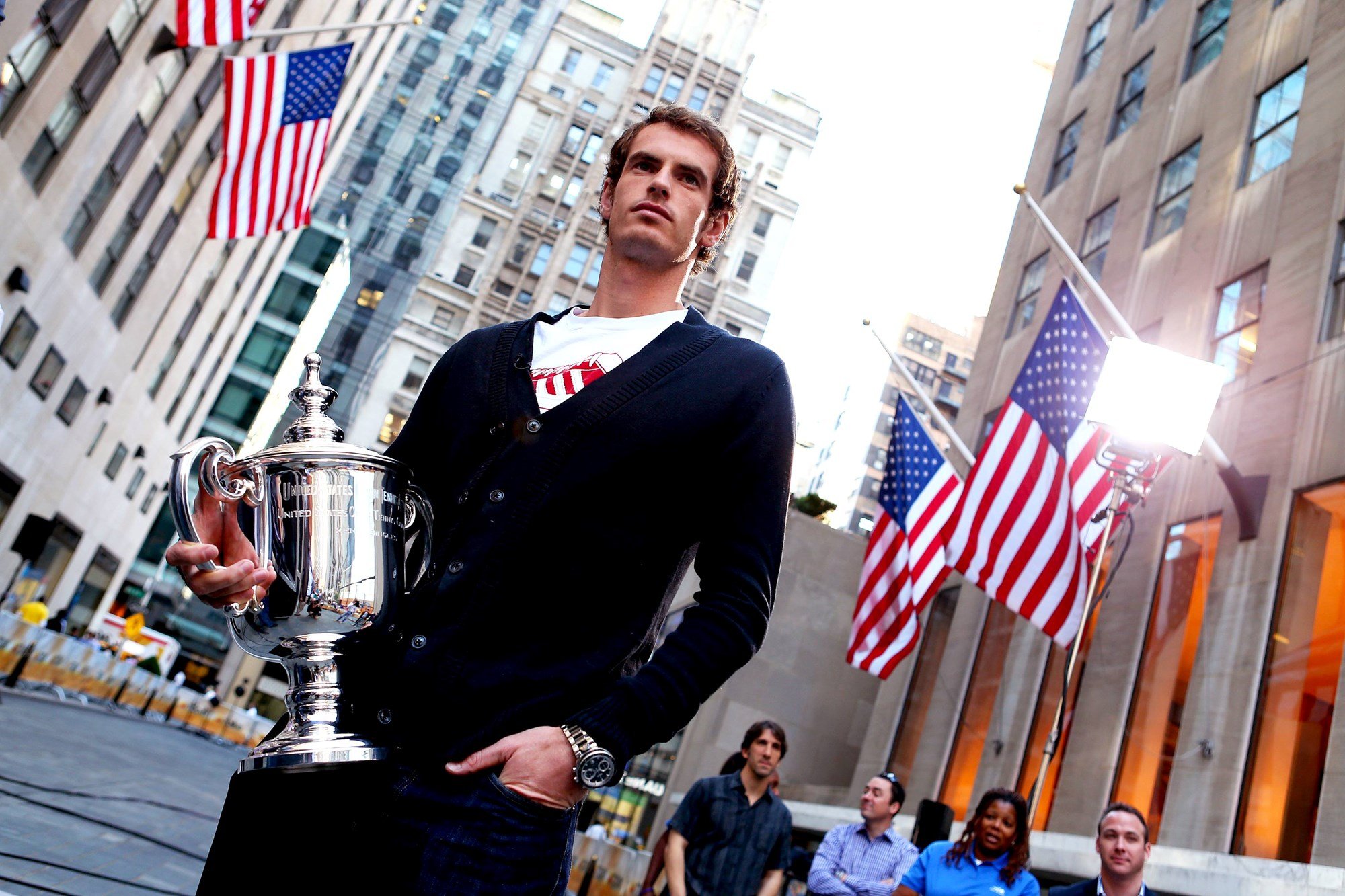 Andy Murray walking through the streets of New York holding the 2012 US Open title