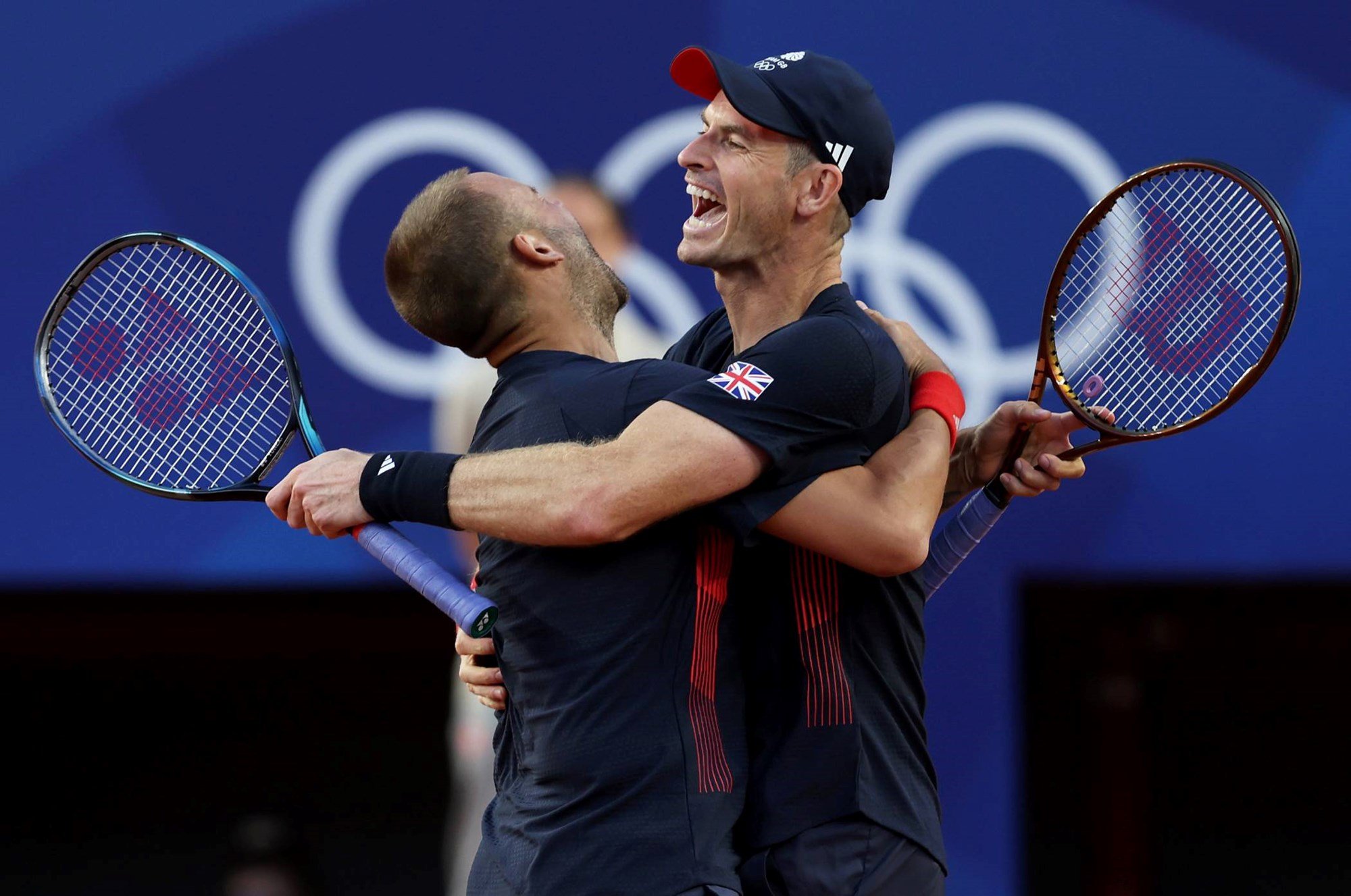 Dan Evans and Andy Murray of Team Great Britain celebrate after winning match point against Kei Nishikori and Taro Daniel at the 2024 Paris Olympics