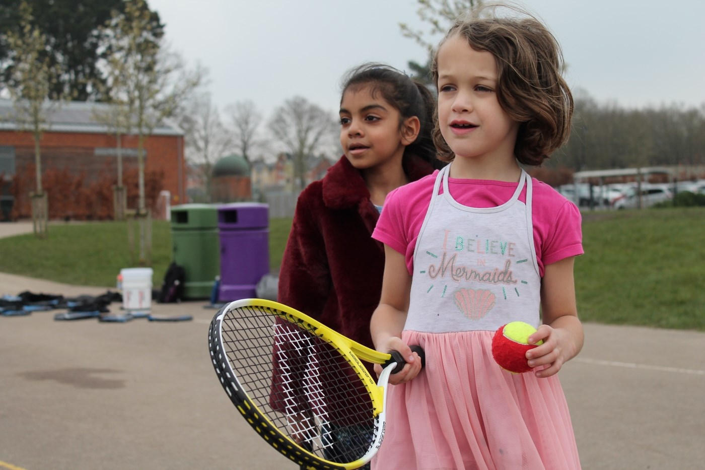 Two primary school students taking part in a tennis session