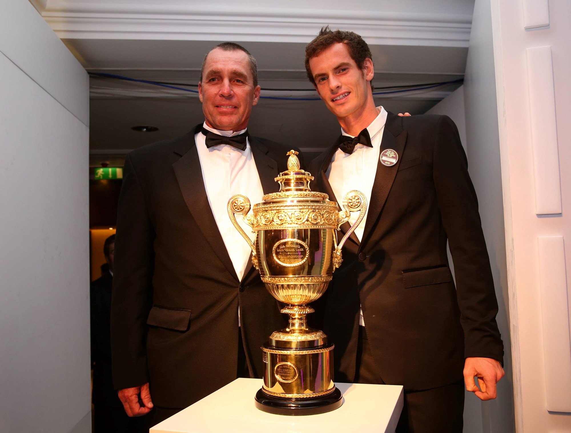 2013 Wimbledon men's singles champion Andy Murray poses with coach Ivan Lendl with the trophy at the Wimbledon Winners Ball