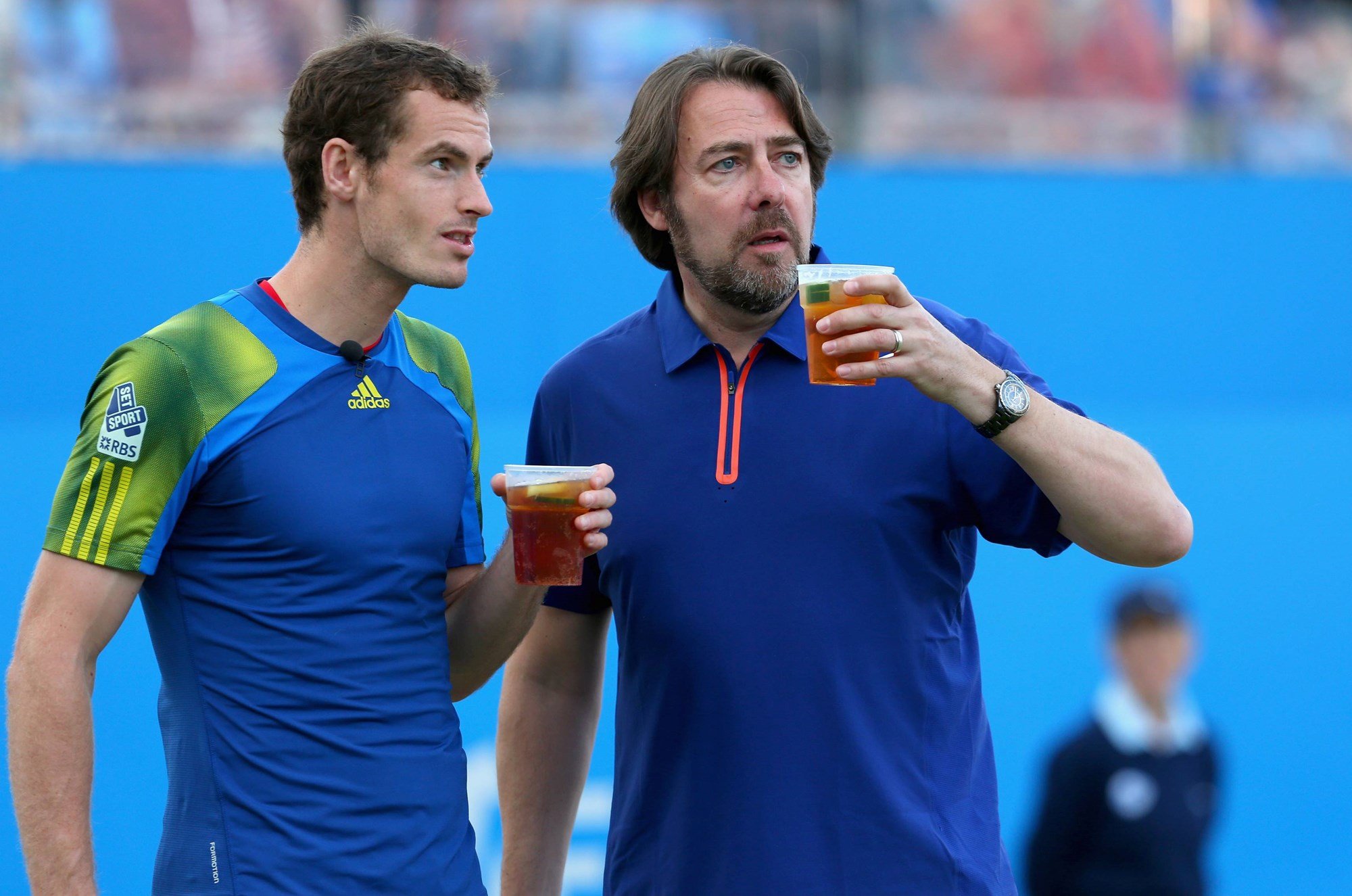 Andy Murray and Jonathan Ross drink Pimms on the court during the Rally Against Cancer charity match at the Queen's Club Championships 2013