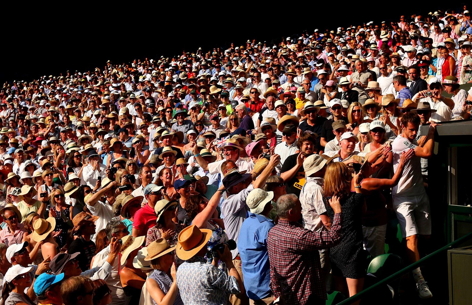 Andy Murray climbs through the Wimbledon crowd after winning the 2013 final against Novak Djokovic