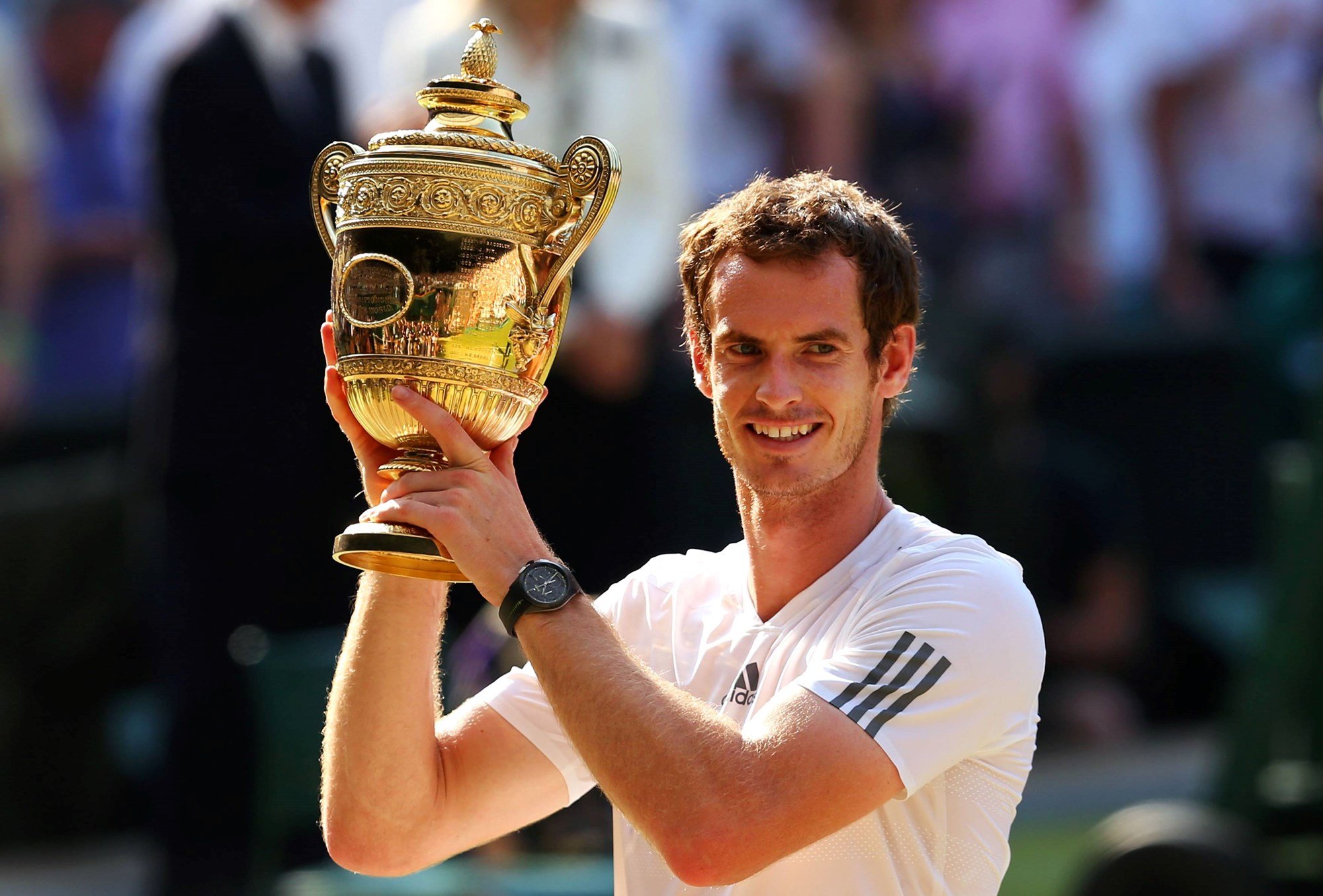 Andy Murray poses with the Wimbledon men's singles trophy after beating Novak Djokovic in the 2013 final