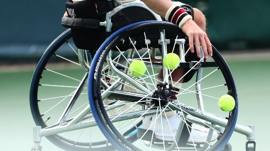 Wheelchair close up with tennis balls in wheel of chair