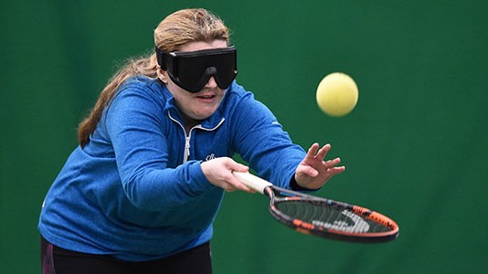 Visually impaired woman playing tennis