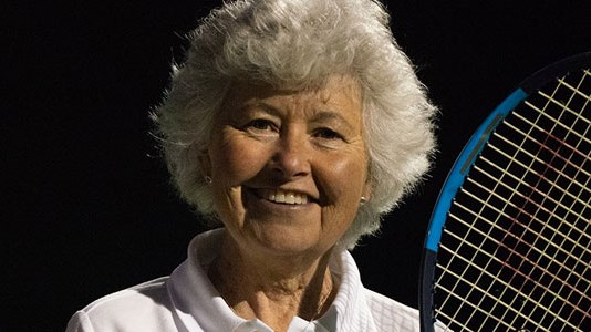 Sarah Strawbridge smiles with her tennis racket in hand