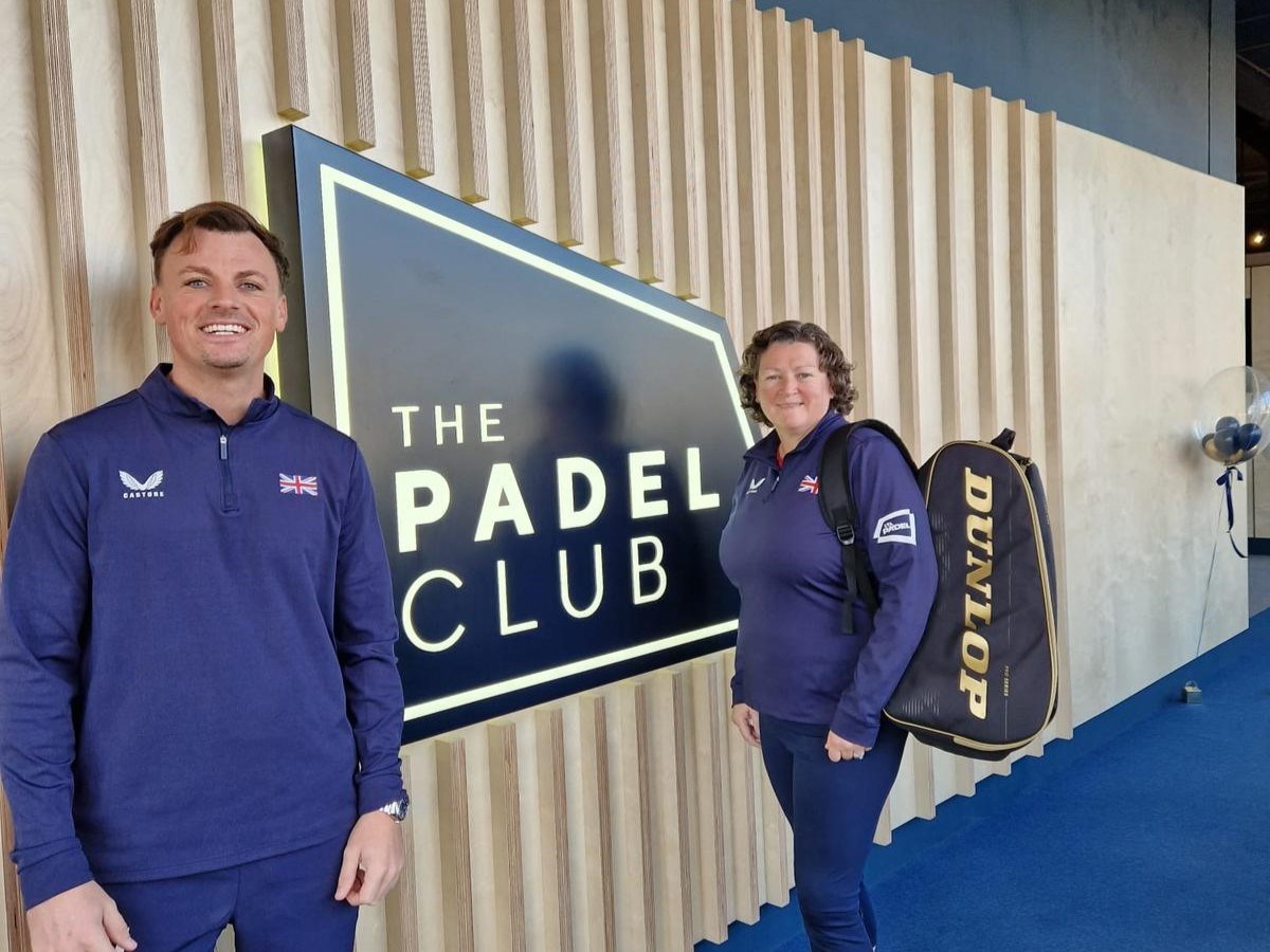 British padel player Frankie Langan and National Coach Libby Fletcher stood infront of a The Padel Club sign at Gloucester Quays