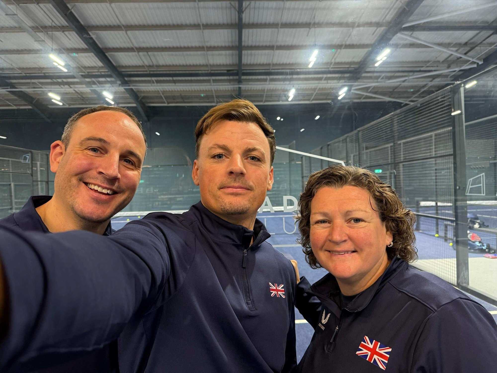 LTA Padel Manager Steve Yeardley, British padel player Frankie Langan and National Coach Libby Fletcher smiling on court at the Padel Club at Gloucester Quays