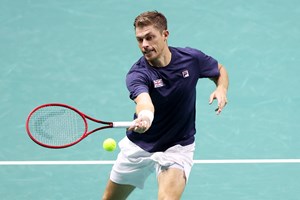 Neal Skupski hitting a forehand on court at the Davis Cup Group Stages in Manchester