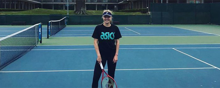 Harriet Dart smiling on tennis court at the NTC