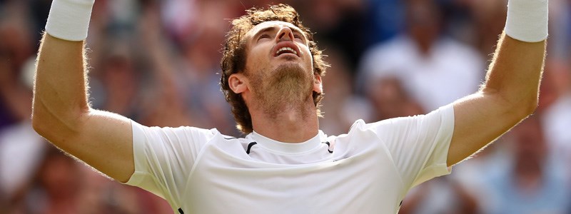 Andy Murray raising his arms after a tennis victory