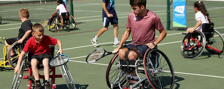 wheelchair adults and juniors rackets in hand practicing skills on tennis courts  