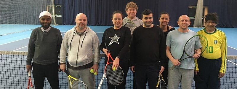 Players pose for a group picture at the net at a Lee valley coaching session
