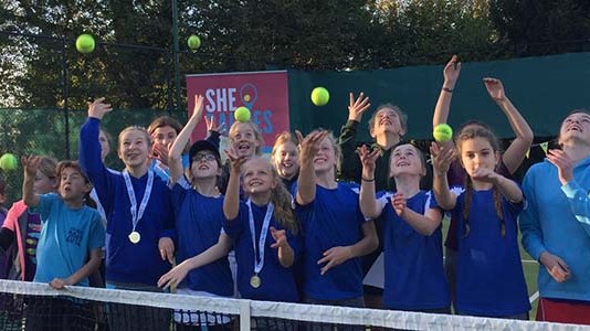Young girls at Bishop Sutton Tennis club throwing up tennis balls