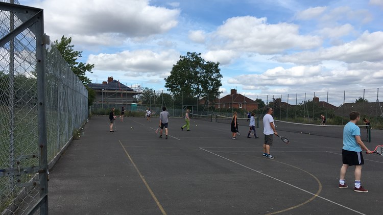 People playing on outdoor courts in Bedminster