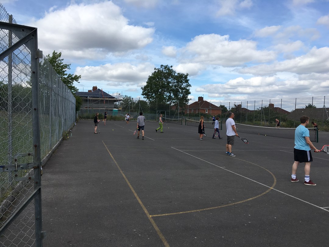 People playing on outdoor courts in Bedminster