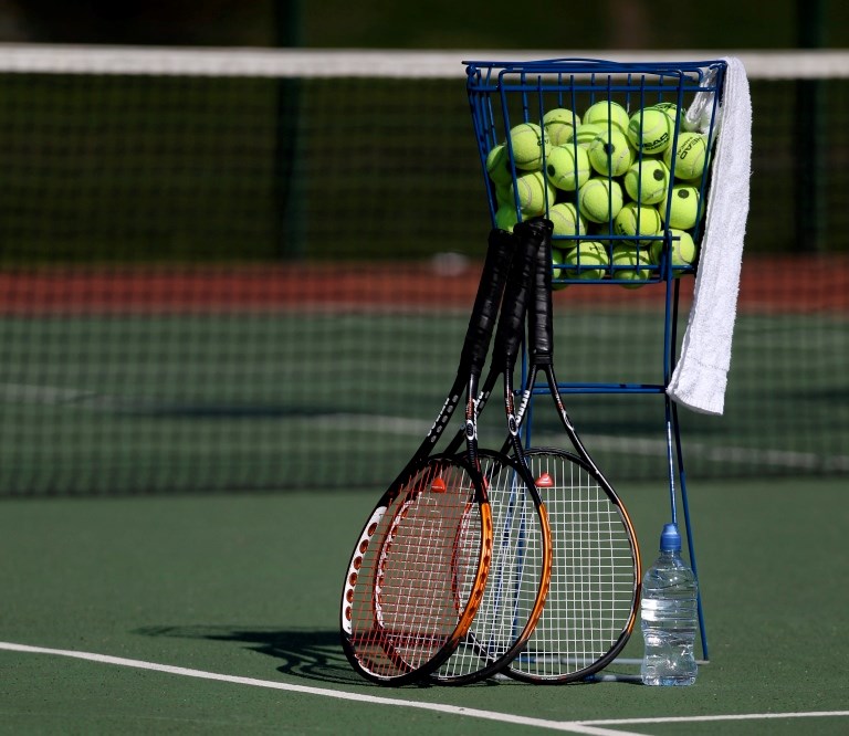 Tennis rackets with tennis balls on a court