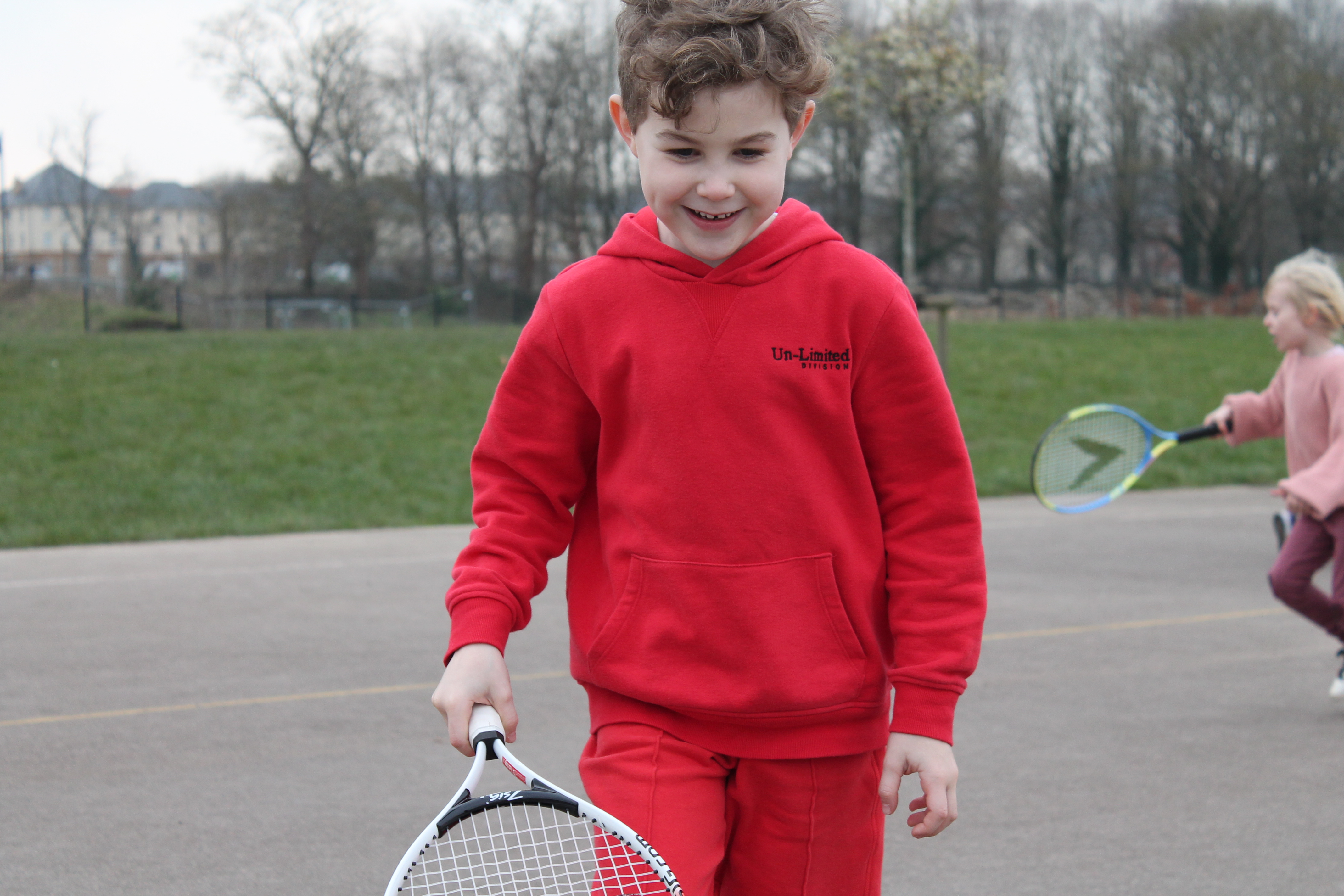 Primary school student enjoying tennis session 