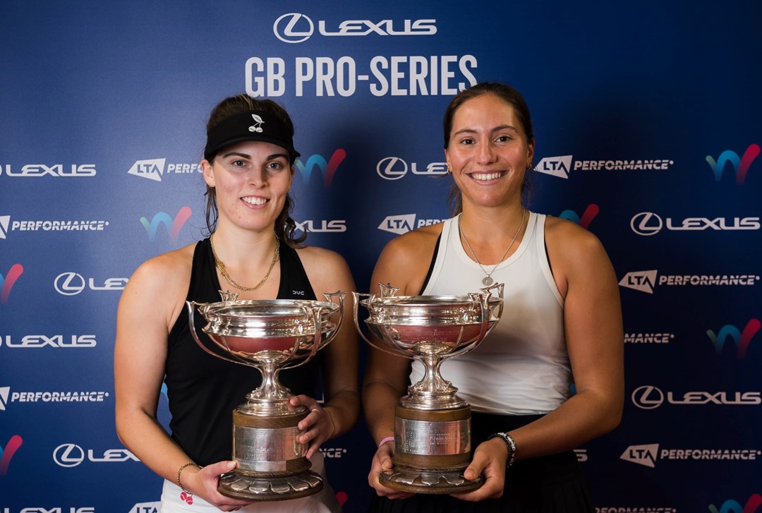 Maia Lumsden and Francisca Jorge holding their doubles trophies at the Lexus GB Pro Series event in Glasgow