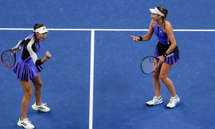 British tennis player Olivia Nicholls and doubles partner Tereza Mihalikova celebrating with each other on court at the China Open