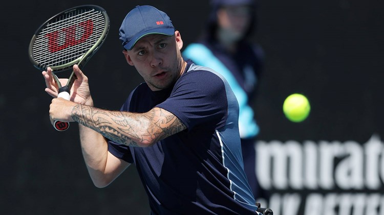 British quad tennis player Andy Lapthorne preparing to hit a backhand slice on court at the 2024 Australian Open