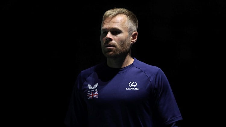 LTA Tennis Coach Mark Hilton wearing a Castore and Lexus branded t-shirt with a logo of the Great Britain flag while on court at the Davis Cup in Manchester